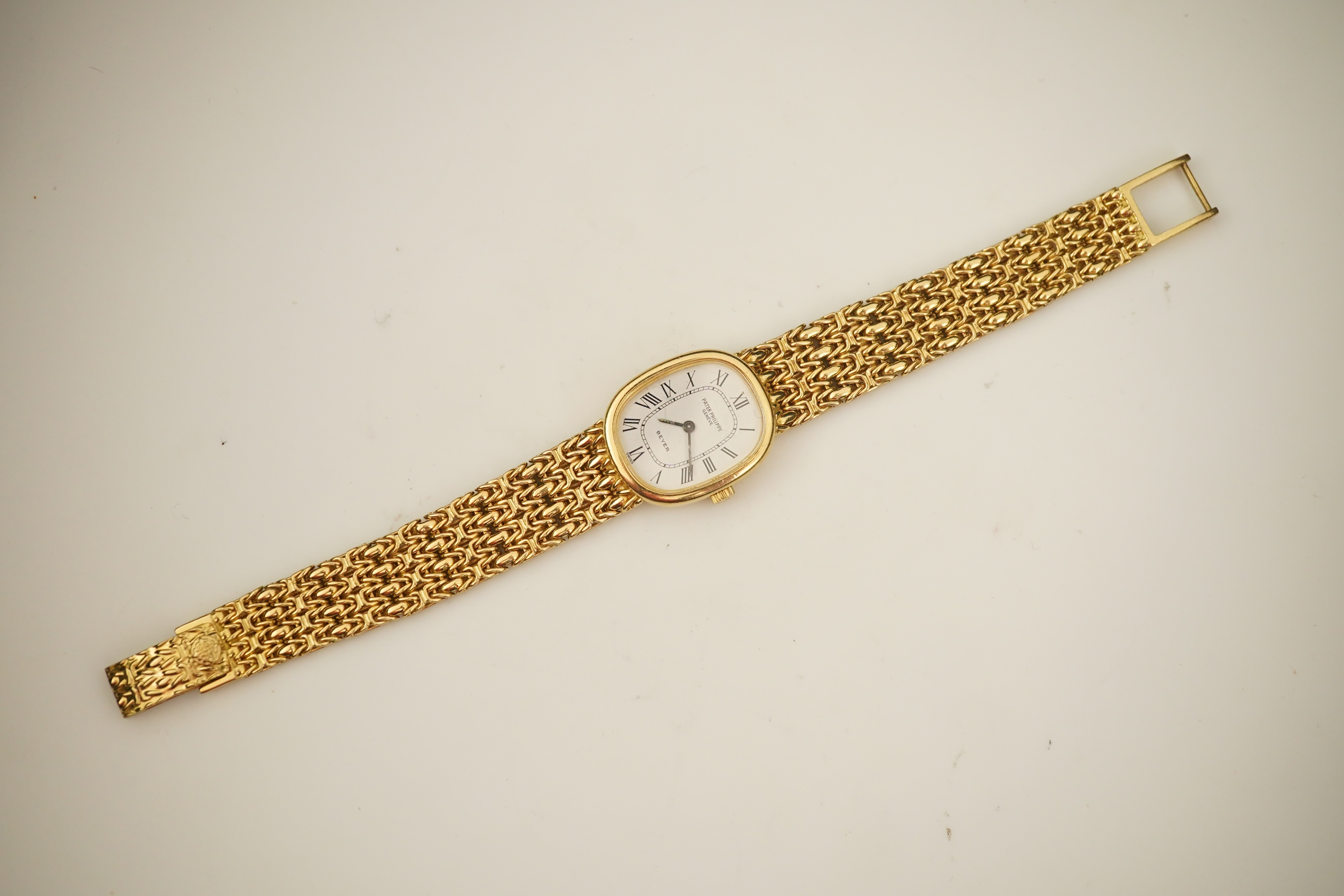 A lady's 18ct gold Patek Philippe manual wind wrist watch, on an integral 18ct gold Patek Philippe bracelet